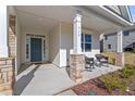 Inviting front porch features stone pillar bases and cozy seating, providing a welcoming entrance at 517 Edenfield Dr, Fuquay Varina, NC 27526