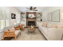 Bright living room with fireplace, built-in shelving, neutral furniture, and light hardwood floors provides a cozy ambiance at 520 Tall Oaks Dr, Durham, NC 27713