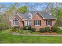 Beautiful brick home with a manicured lawn and shrubbery adding to its curb appeal at 5900 Orchid Valley Rd, Raleigh, NC 27613
