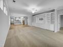 Open-concept living room featuring hardwood floors and built-in shelving at 611 Atticus Way, Durham, NC 27703