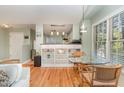 Cozy dining area featuring hardwood floors and natural light from a large window at 707 Cross Timbers Dr, Durham, NC 27713