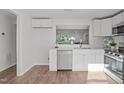 Bright and airy kitchen with stainless steel appliances, white cabinets, and hardwood flooring at 7715 Bernadette Ln, Raleigh, NC 27615