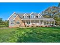 Beautiful home with stone accents, welcoming front porch, and a spacious, well-manicured lawn at 9026 Privette Hill Ln, Spring Hope, NC 27882