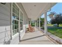 Inviting front porch with rocking chairs, offering a relaxing outdoor space with lovely views at 9026 Privette Hill Ln, Spring Hope, NC 27882
