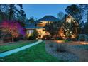 Charming two-story home with a walkway leading to the front door, beautifully lit at dusk at 10001 Sandcreek Ct, Chapel Hill, NC 27517
