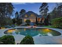 View of home's backyard with a swimming pool, patio and outdoor seating at 10001 Sandcreek Ct, Chapel Hill, NC 27517