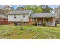 A cozy porch and a well-kept yard provide a peaceful outdoor space at 101 W Thorndale Dr, Oxford, NC 27565