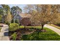 Beautifully landscaped front yard with a large tree and well-maintained lawn at 102 Kamprath Pl, Cary, NC 27519