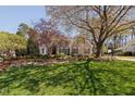 Green front yard with landscaped garden beds and rock borders leading up to the house at 102 Kamprath Pl, Cary, NC 27519