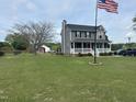 A large home with an ample front yard and an American flag waving proudly at 1020 Retriever Ln, Raleigh, NC 27603