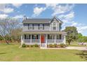 Inviting two-story home with a charming front porch, perfect for relaxing outdoors at 1020 Retriever Ln, Raleigh, NC 27603