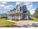 Charming two-story home features a spacious front porch, well-manicured lawn, and classic architectural details at 1020 Retriever Ln, Raleigh, NC 27603