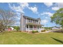 Charming two-story home features a spacious front porch, well-manicured lawn, and classic architectural details at 1020 Retriever Ln, Raleigh, NC 27603