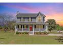 Charming two-story home features a spacious front porch, well-manicured lawn, and classic architectural details at 1020 Retriever Ln, Raleigh, NC 27603