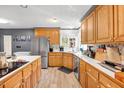 Well-equipped kitchen boasts oak cabinets, stainless steel appliances, and ample counter space at 105 Hobson Pl, Louisburg, NC 27549