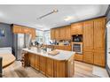 Spacious kitchen featuring a center island, oak cabinets and stainless-steel appliances at 105 Hobson Pl, Louisburg, NC 27549