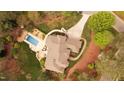 Stunning aerial view of a sprawling home with a private pool and a long driveway at 11 Swallow Tail Ct, Pittsboro, NC 27312