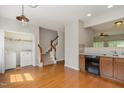 Traditional kitchen with hardwood floors, wood cabinetry, and a view of the staircase at 117 Gallent Hedge Trl, Apex, NC 27539