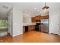 Traditional kitchen with hardwood floors, stainless steel refrigerator, and wood cabinetry at 117 Gallent Hedge Trl, Apex, NC 27539