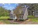 Well-kept home with neutral siding, dormer windows, manicured landscaping, and a paved walkway at 120 Stillmeadow Dr, Louisburg, NC 27549