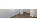 Bright room featuring modern flooring, fresh paint, and a door with glass panels at 121 Pisgah St, Sanford, NC 27330