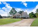 Inviting home with a well-maintained lawn, attractive landscaping, and long driveway at 13 Parkers Pointe Dr, Benson, NC 27504