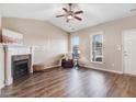 Bright living room boasts vaulted ceilings, a ceiling fan, fireplace, and hardwood floors at 13 Parkers Pointe Dr, Benson, NC 27504