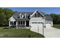 Charming two-story home featuring stone accents and a spacious three-car garage at 14 Cricket Hill Way, Benson, NC 27504