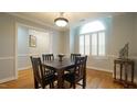Elegant dining room with hardwood floors, ample natural light, and wainscoting at 1415 Quarter Pt, Raleigh, NC 27615