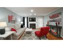 Inviting living room featuring a fireplace, hardwood floors, and stylish decor at 1415 Quarter Pt, Raleigh, NC 27615