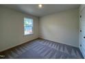 Bedroom featuring neutral-colored walls, carpet, and a bright window at 152 Parker Ln, Mebane, NC 27302