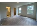Spacious bedroom features natural light from two windows and neutral carpet flooring at 152 Parker Ln, Mebane, NC 27302