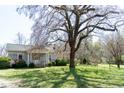 Exterior shot of the front of a single-story home with mature trees at 1556 Pleasants Rd, Wendell, NC 27591