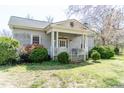 Charming single-story home with a columned front porch and mature landscaping at 1556 Pleasants Rd, Wendell, NC 27591