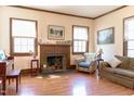 Cozy living room featuring a fireplace, wood floors, and bright natural light at 1556 Pleasants Rd, Wendell, NC 27591