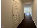 Hallway leading to living area with hardwood floors and plenty of natural light at 158 Parker Ln, Mebane, NC 27302