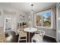 Cozy breakfast nook with a bistro table, modern chairs, and a large window providing natural light and views at 19 Lansgate Ct, Durham, NC 27713