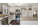 Bright kitchen with granite countertops and stainless steel appliances at 19 Lansgate Ct, Durham, NC 27713