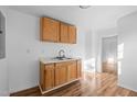 Well-lit kitchenette with wood cabinetry, laminate countertop, and modern faucet at 203 W Pilot St, Durham, NC 27707
