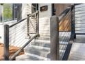 Front entryway features steps, a modern railing, and a painted brick facade for a welcoming entrance at 206 Bickett Blvd, Raleigh, NC 27608