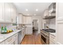 Bright kitchen featuring stainless steel appliances, granite countertops and beautiful hardwood floors at 206 Bickett Blvd, Raleigh, NC 27608