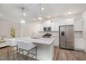 A modern kitchen featuring white cabinetry, a large island with quartz countertops, and stainless steel appliances at 210 Silas St, Durham, NC 27705