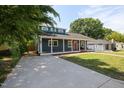 Charming blue home with a large driveway leading to a welcoming covered front porch at 211 Hargrove St St, Durham, NC 27701