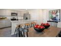 Kitchen showcases stainless steel appliances, granite countertops, bar stool seating, and a dining area at 214 Oak Barrel St, Smithfield, NC 27577