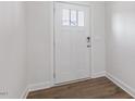 Bright entryway featuring a white door, modern lockset, and wood-look flooring at 2322 Sugar Cone Way, Fuquay Varina, NC 27526