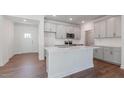 Modern kitchen featuring gray cabinets, stainless steel appliances, and a large center island at 2322 Sugar Cone Way, Fuquay Varina, NC 27526