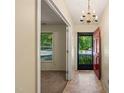 Inviting entryway with a red door, stylish chandelier, and easy access to a bright living space at 2417 Lawrence Dr, Raleigh, NC 27603