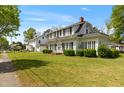 Charming two-story home with black shutters, landscaped yard, and inviting front entrance at 305 N Ellis Ave, Dunn, NC 28334