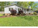 Single-story house featuring a light-gray exterior, well-maintained landscaping, and a front porch at 313 Dunhagan Pl, Cary, NC 27511