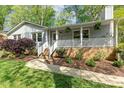 This home features a lovely front porch with white columns and brick accents at 313 Dunhagan Pl, Cary, NC 27511